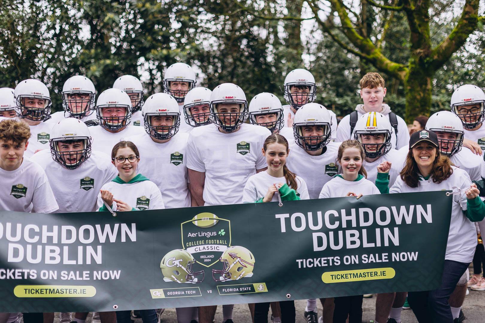 A group of players showcasing the poster for the Aer Lingus College Football Classic